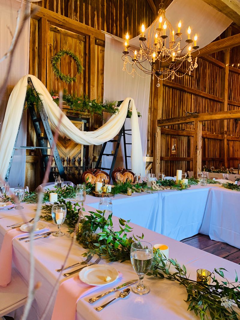 Rustic reception table with chandelier and elegant decor