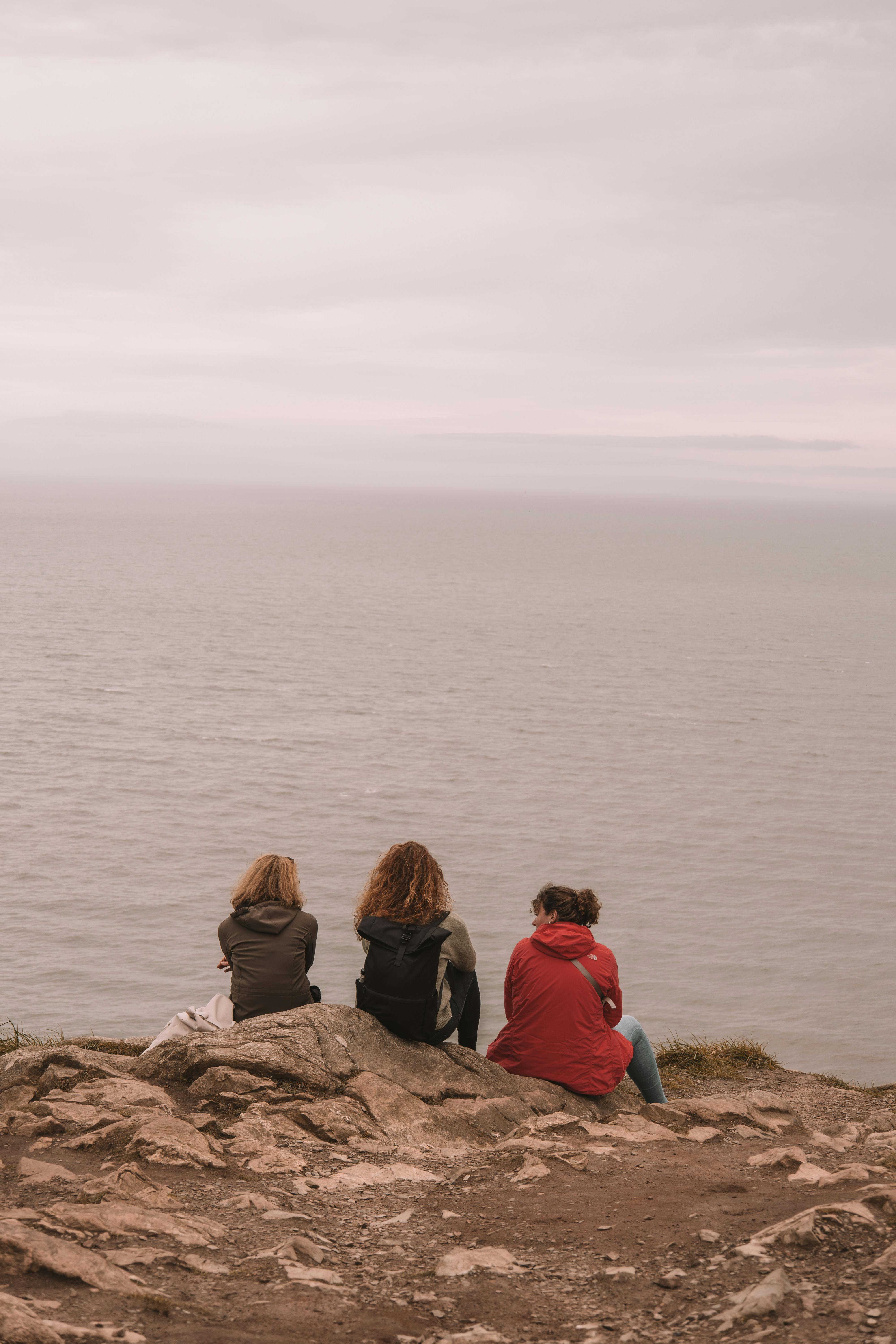 group of women sitting by the sea