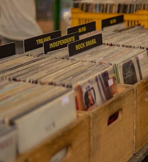 A crate of records on a table with a sign that says vinyl