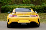 一辆黄色跑车停在户外，展现出时尚的设计和充满活力的色彩