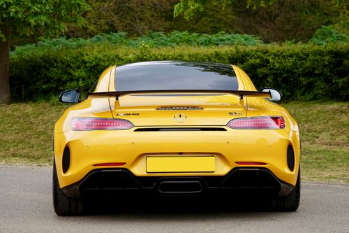Free Yellow sports car parked outdoors, showcasing sleek design and vibrant color. Stock Photo