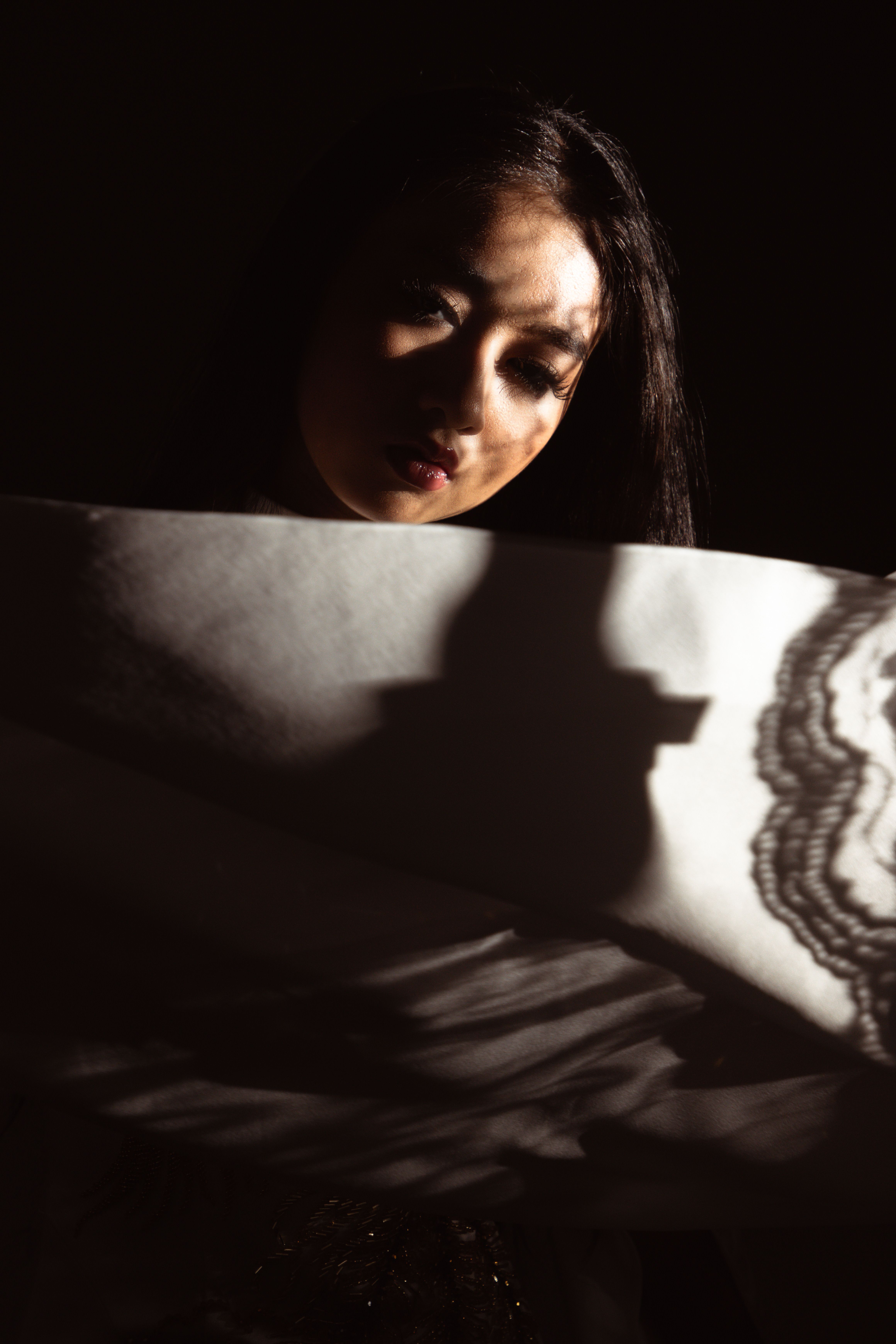 Young Woman in a Dark Room · Free Stock Photo