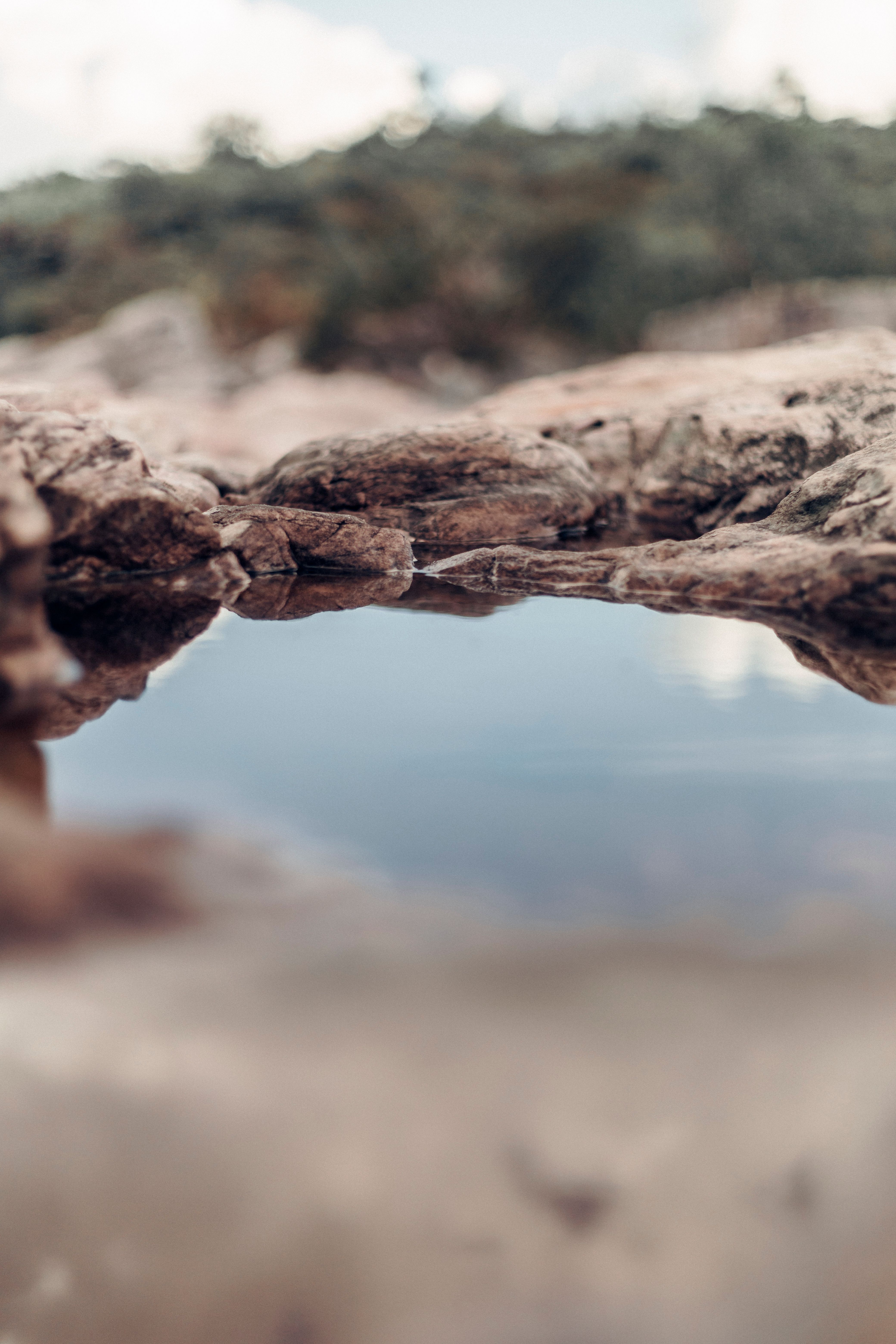 A small pond in the middle of rocks · Free Stock Photo