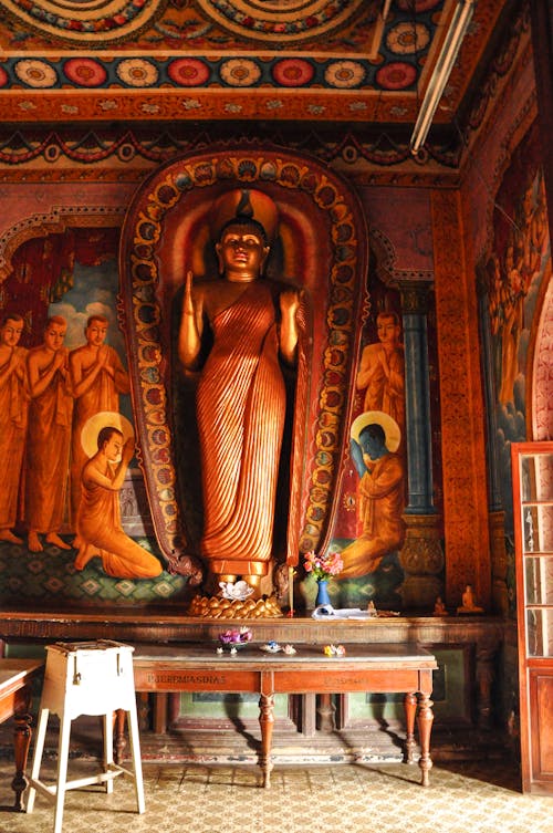 Wooden Tables Inside Building With Statue