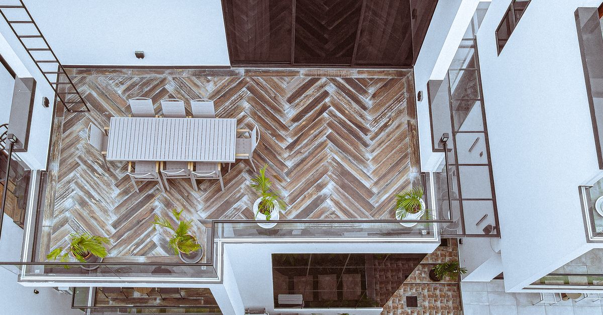 Aerial view of a stylish rooftop terrace with dining area and plants in Dar es Salaam, Tanzania.