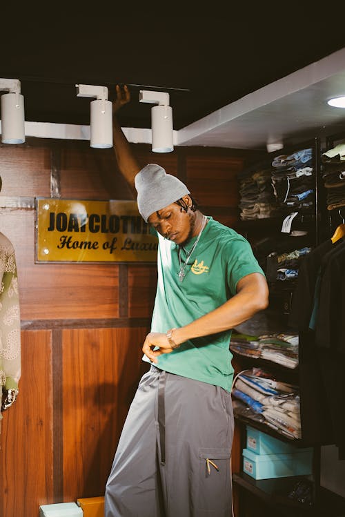 A man in green shirt standing in a room