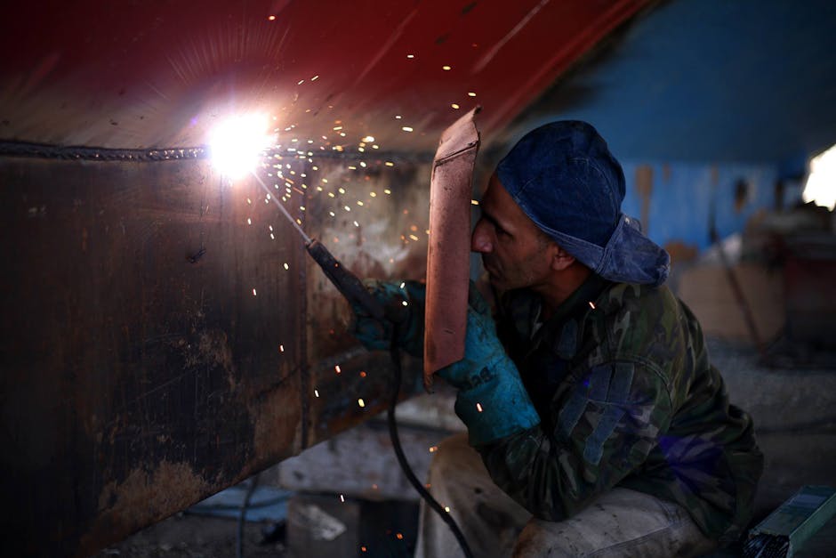 Welding safety equipment including helmet, gloves and protective clothing - diamond plate welding Welding safety equipment including helmet, gloves and protective clothing - diamond plate welding