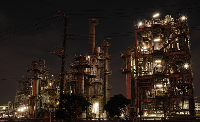 Oil refinery infrastructure illuminated at night
