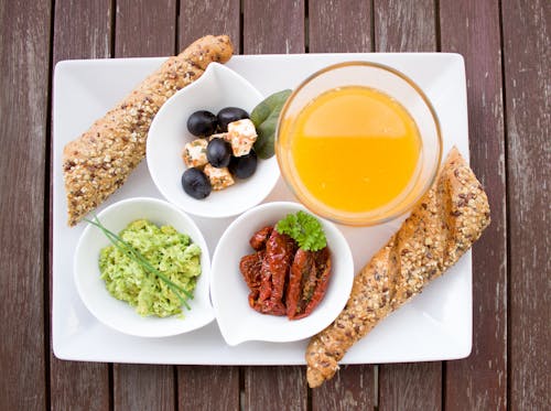 Bread, Juice, and Berries on White Ceramic Plate