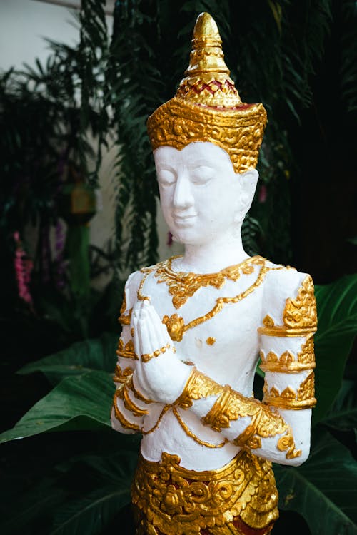 A statue of a buddha in gold and white