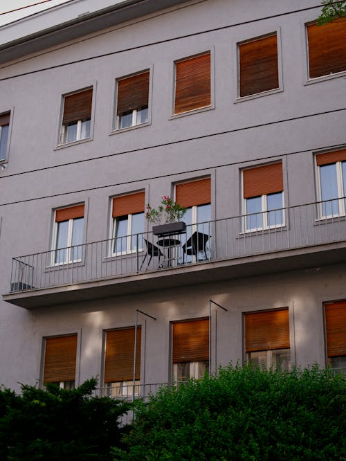 A balcony with chairs on it in front of a building