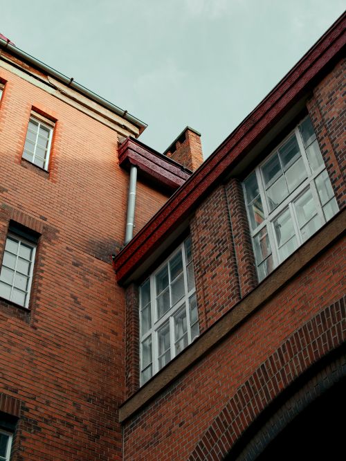 Free Low angle view of brick building with windows, showcasing architectural details in Bratislava. Stock Photo
