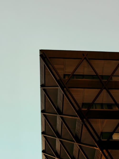 A building with a triangular shape and a blue sky