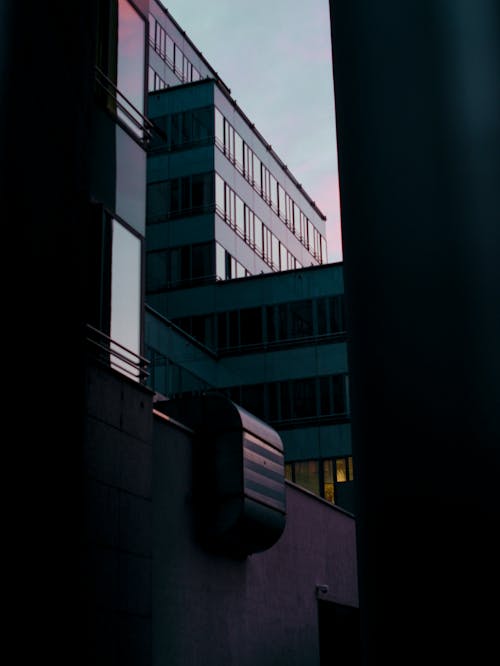 A building with a pink sky and buildings