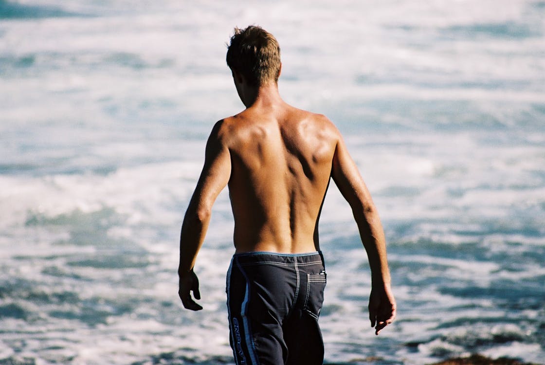 Free Topless Man on Beach Stock Photo