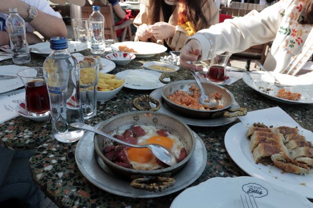 A vibrant Turkish breakfast scene with diverse dishes and tea in a cozy İstanbul café.