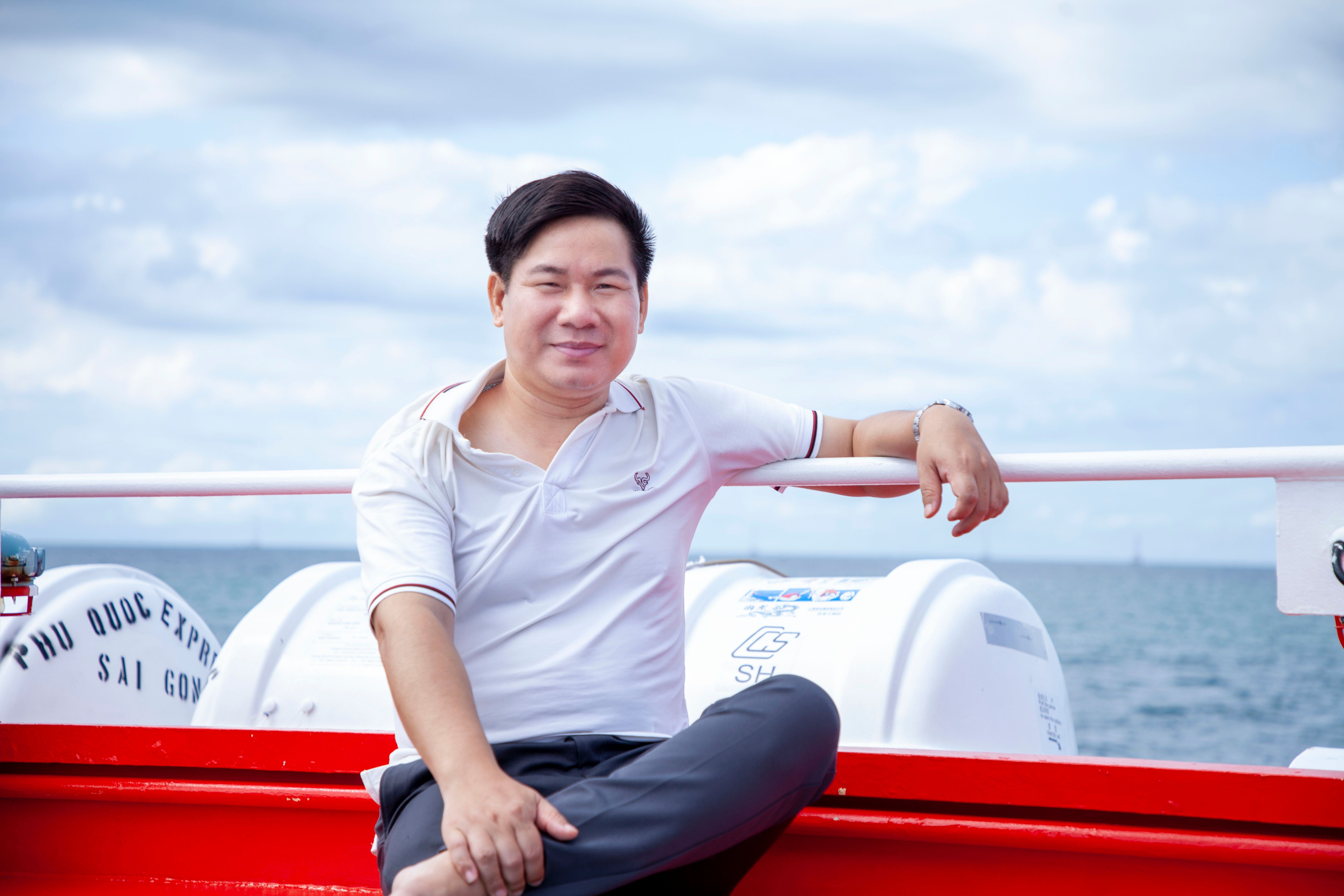 Man enjoying a relaxing moment on a bright cruise ship deck with sea in the background.