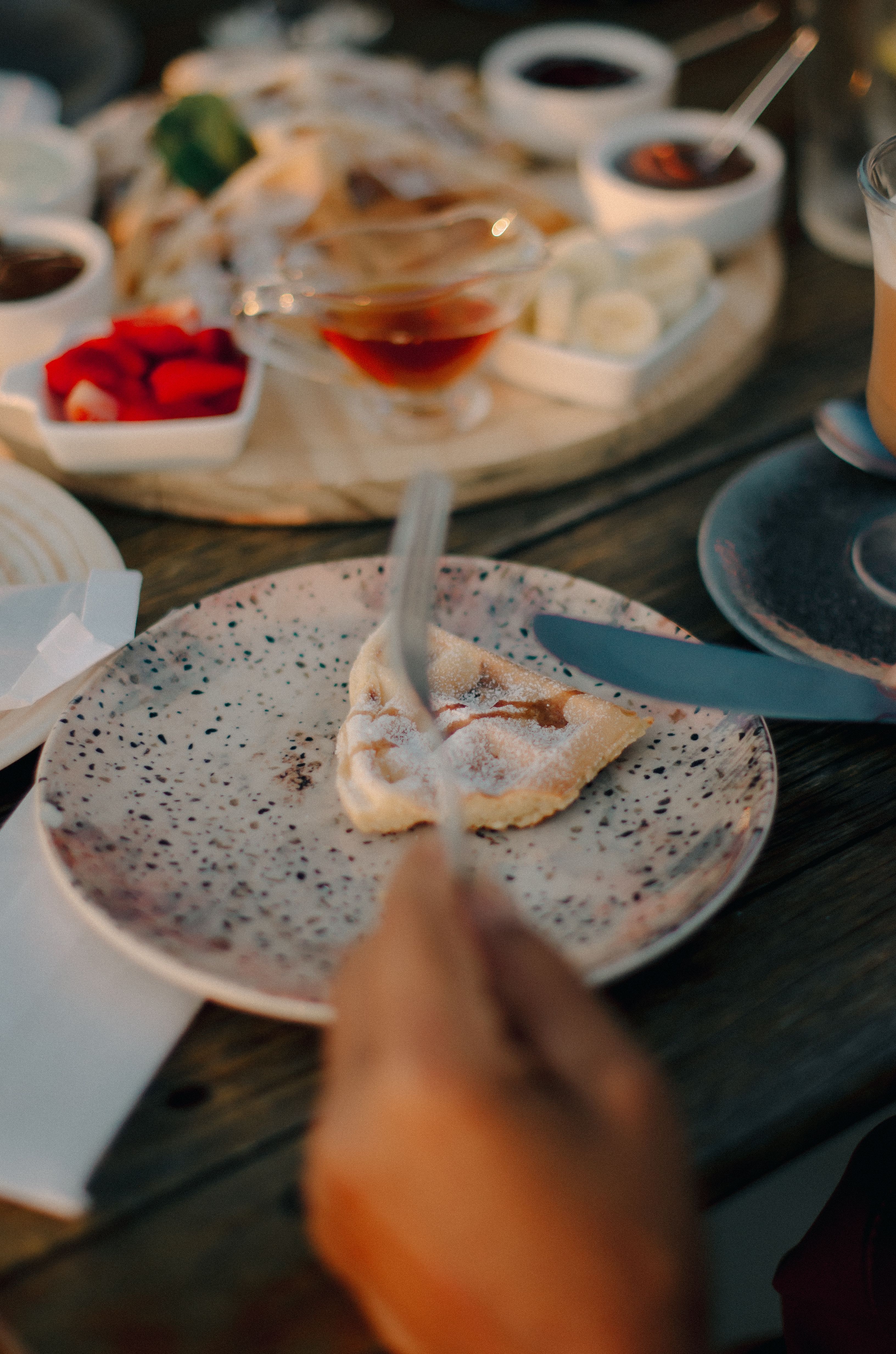 Close-up of a dessert plate with syrup and garnish, perfect for culinary presentations.