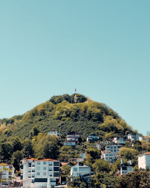 A hill with houses on it and a blue sky