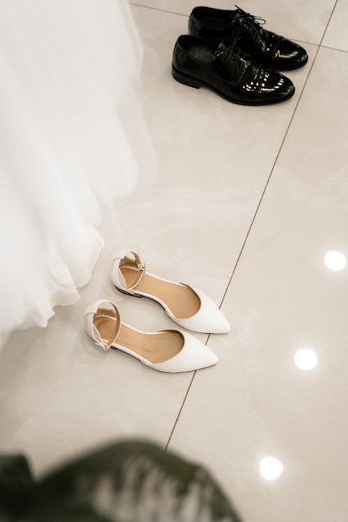 A bride's shoes and a pair of shoes on the floor