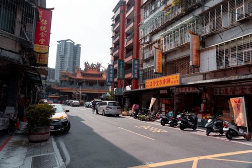 Free A vibrant city street view in Wanhua, Taipei with local shops, traffic, and traditional architecture. Stock Photo