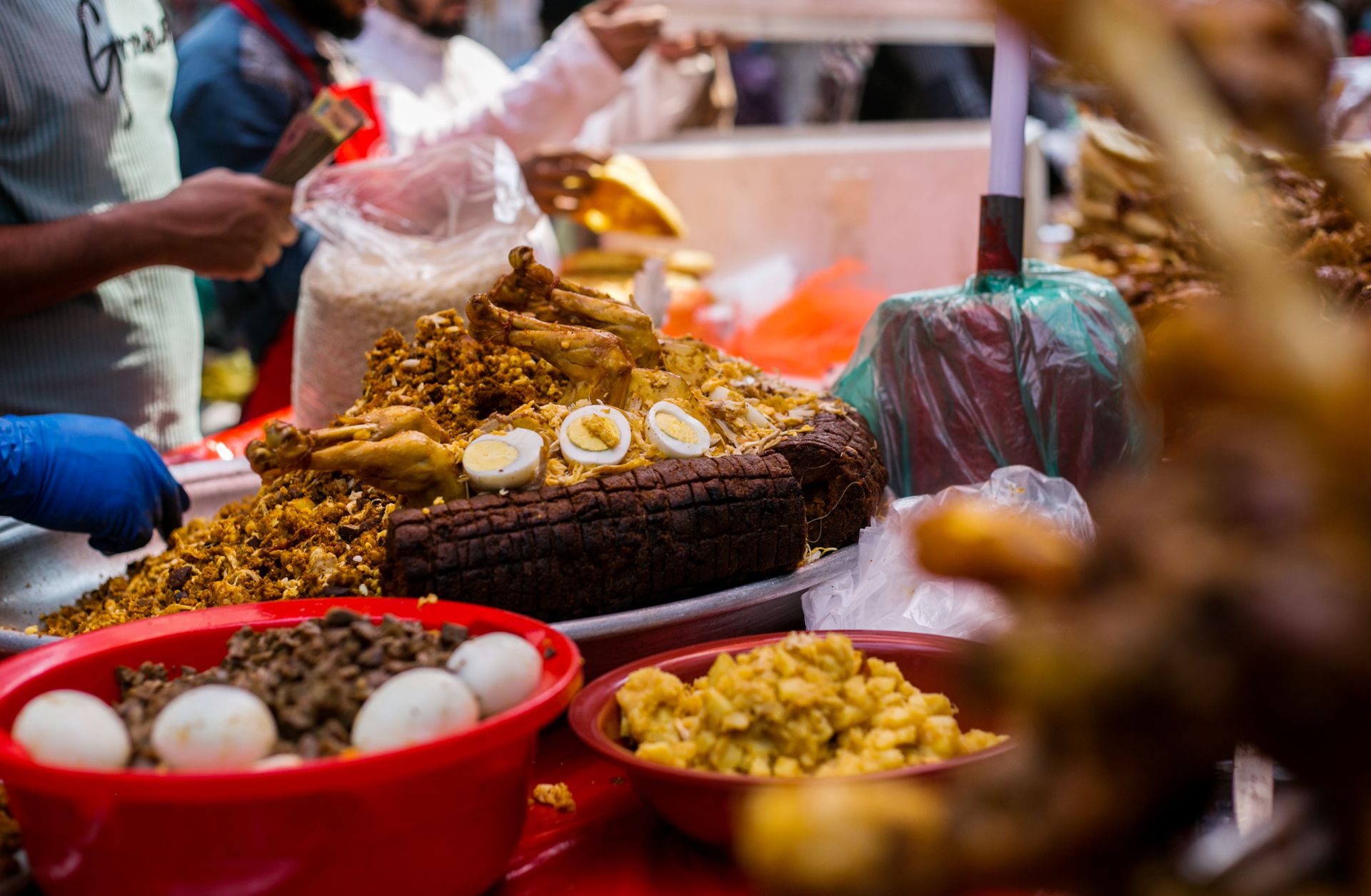 Colorful street market scene with assorted dishes including eggs and chicken, showcasing vibrant street food culture.