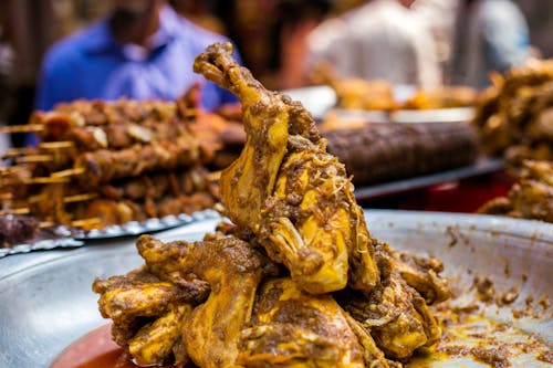 Free A plate of chicken on a table with other food Stock Photo