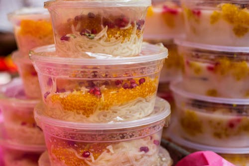 Free A stack of plastic containers filled with food Stock Photo