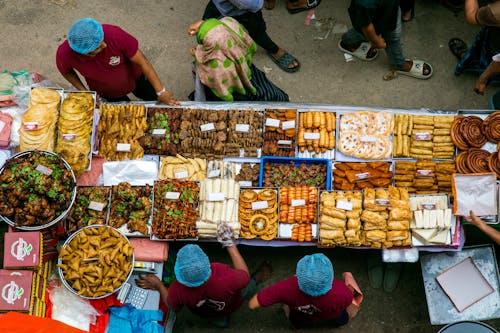 Free A group of people standing around a table with food Stock Photo