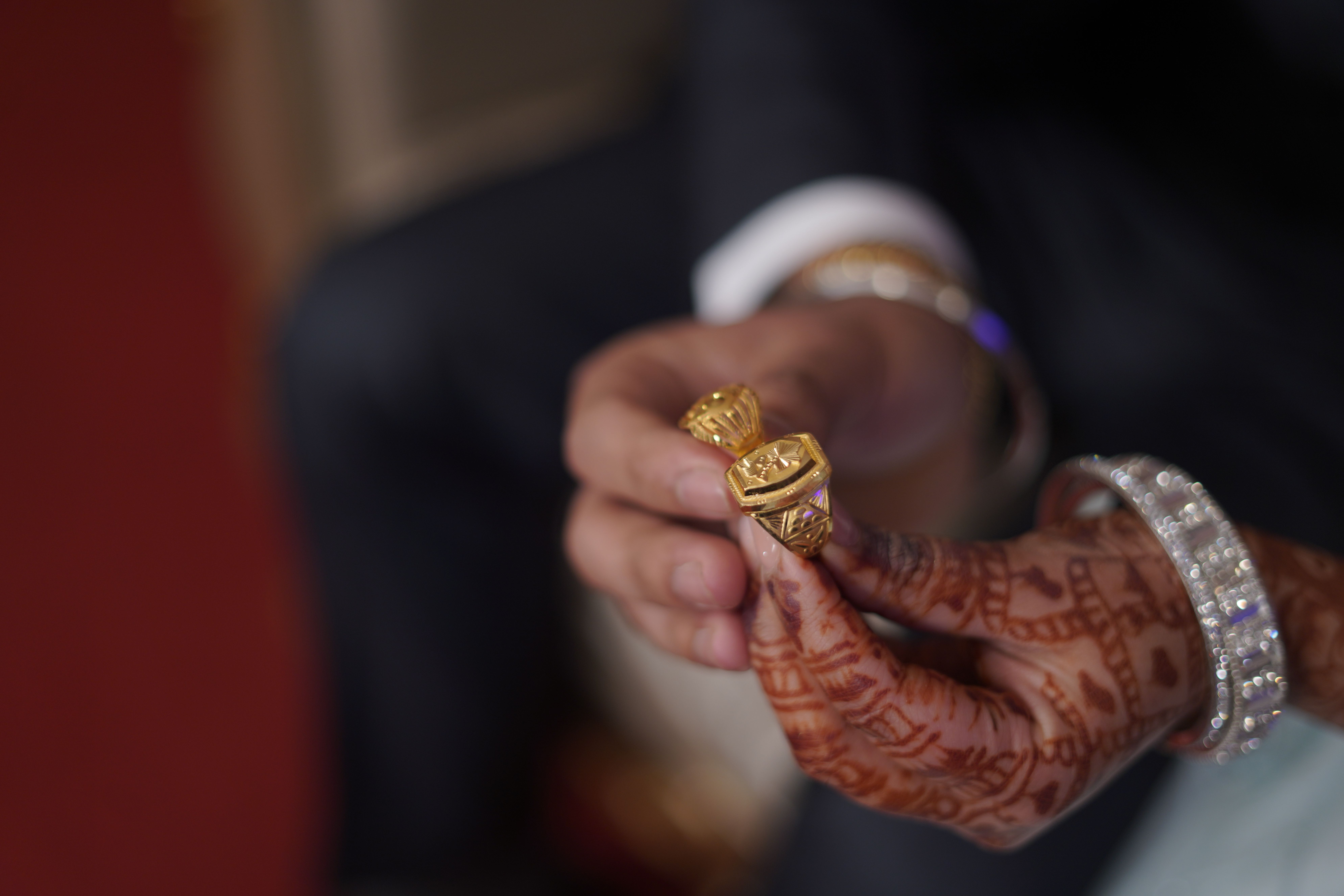 Indian Wedding Couple Exchanging Golden Rings  Free Stock Photo