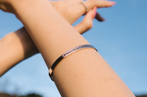 Close-up Photo Of Person Wearing Silver Bracelet