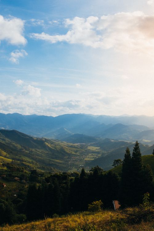 Free Explore the stunning mountain view as the sun rises, casting light across a serene valley. Stock Photo