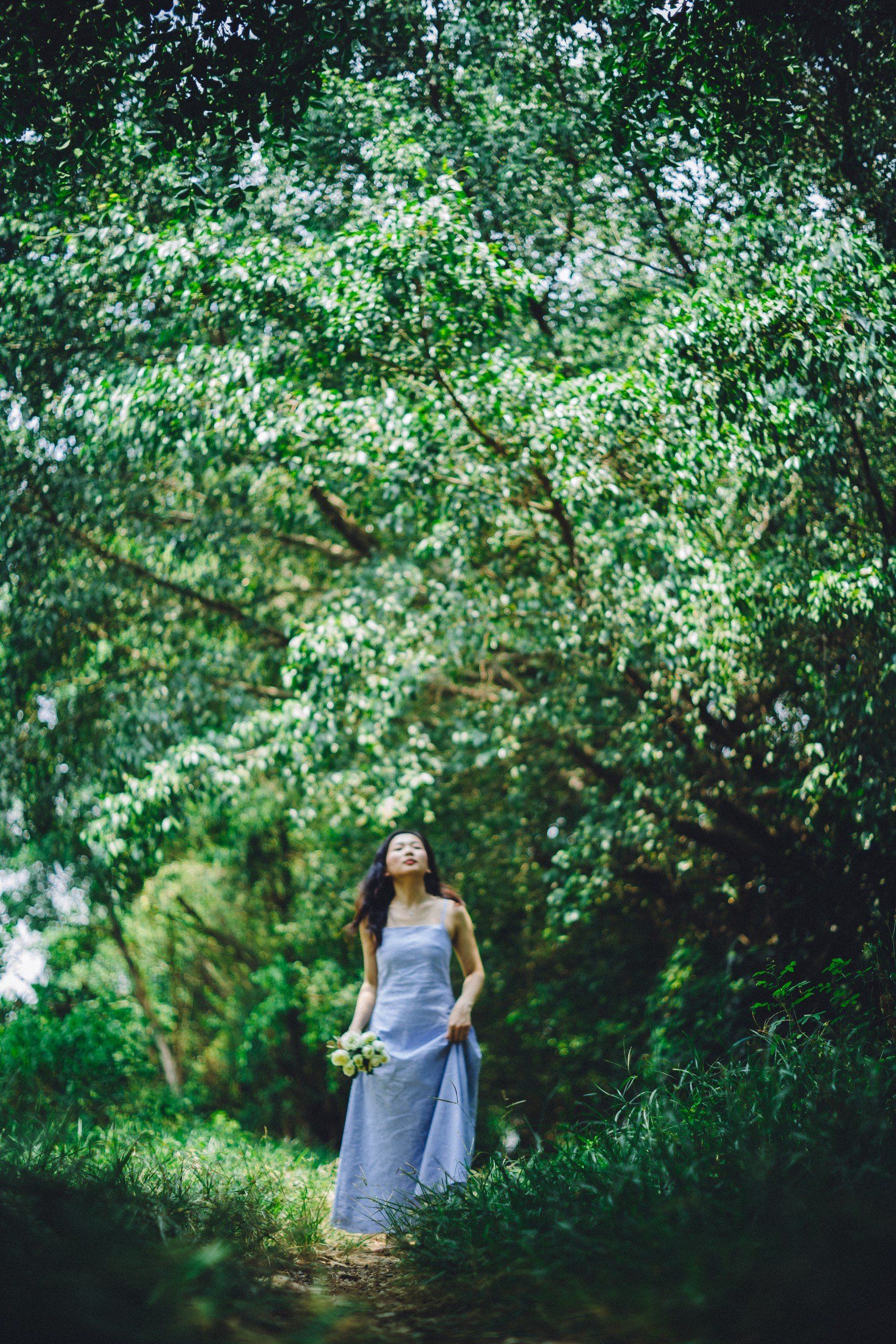 Woman in Blue Dress Walking on Footpath in Forest · Free Stock Photo