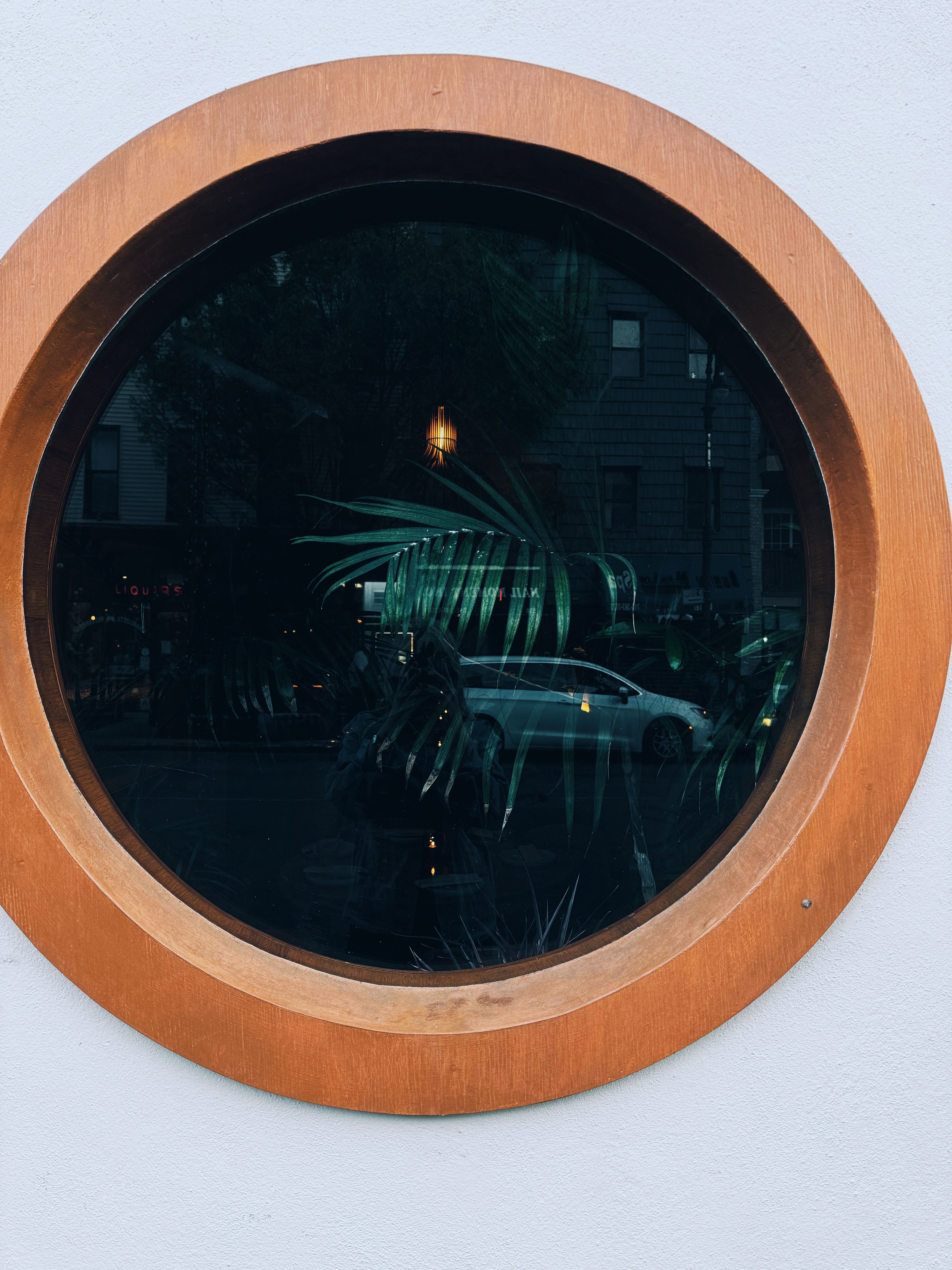 A Car Reflected in a Round Window · Free Stock Photo