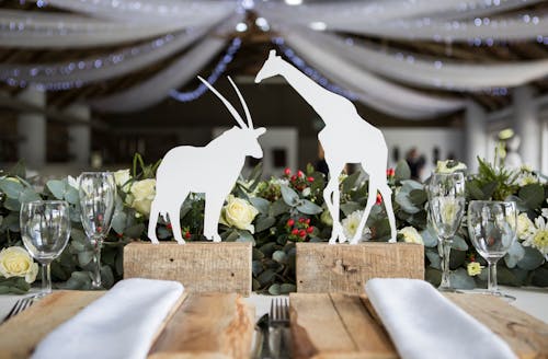 Two White Napkins Across White Silhouette of Animals