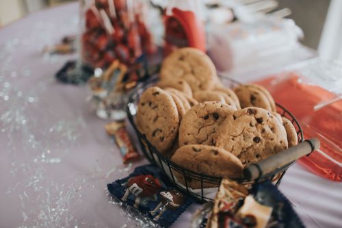 Free Basket of homemade chocolate chip cookies with candy on a festive table. Stock Photo