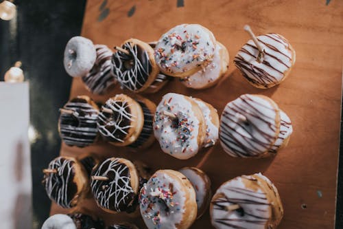 Free Donuts Hanging On Wooden Surface Stock Photo