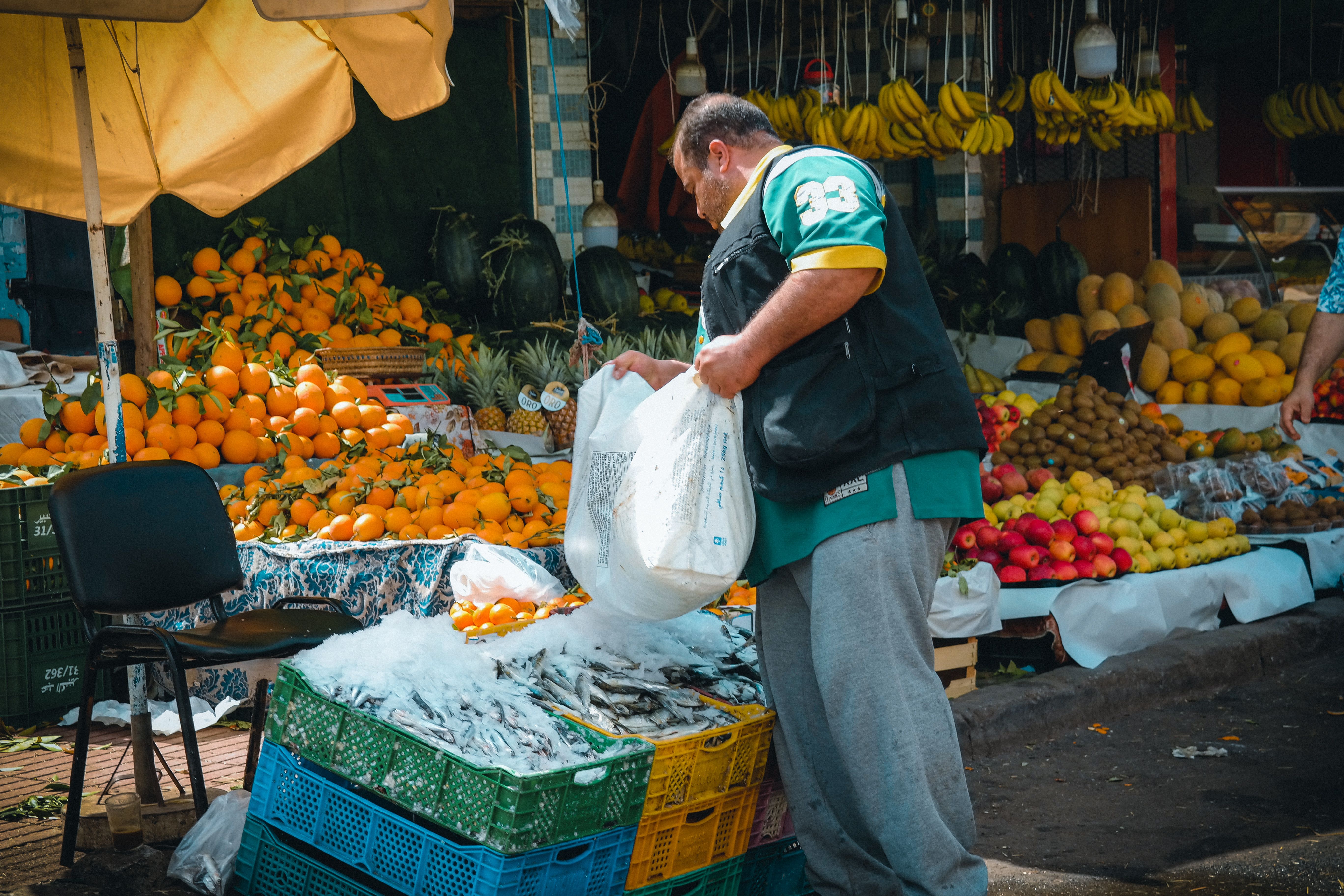 Merchant by Crates of Fish in Ice · Free Stock Photo
