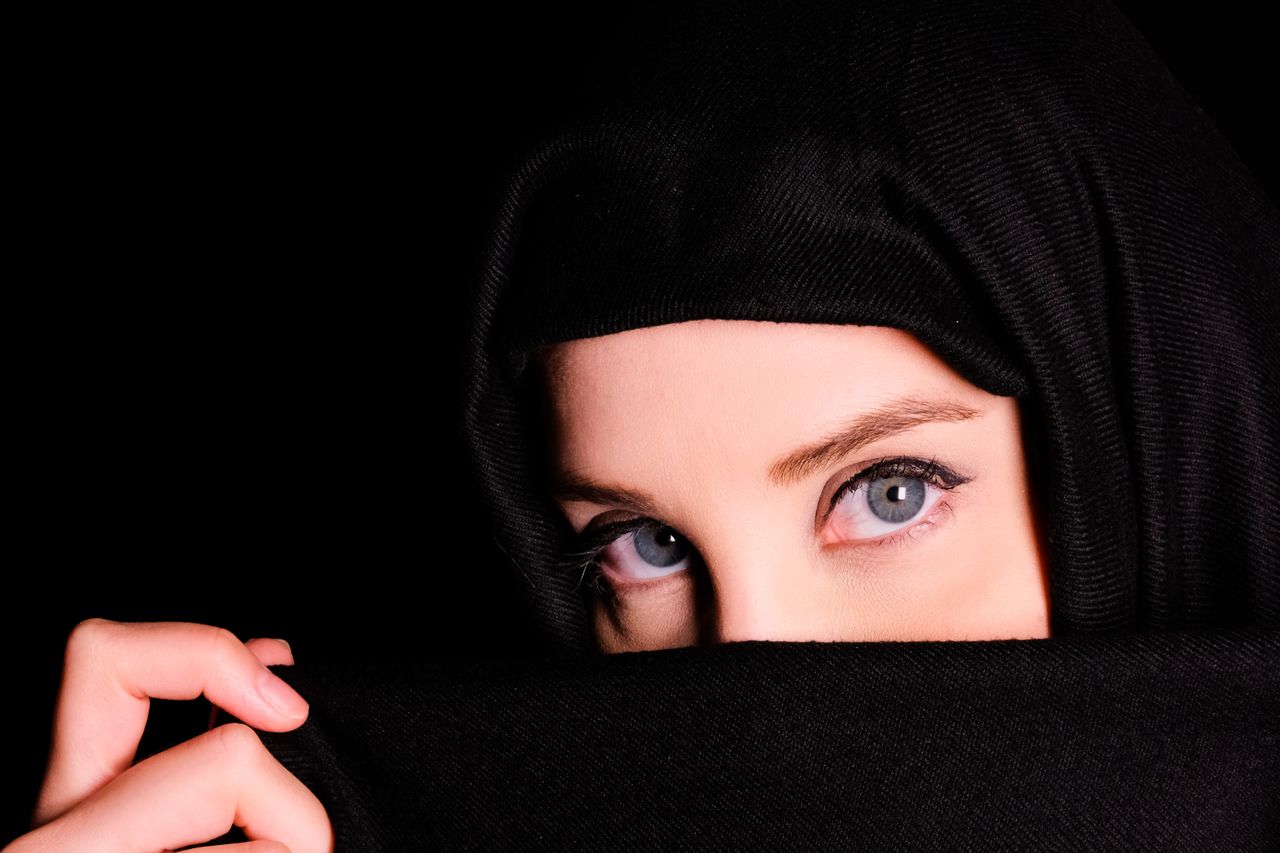 close up portrait of a woman wearing a headscarf revealing only her ey