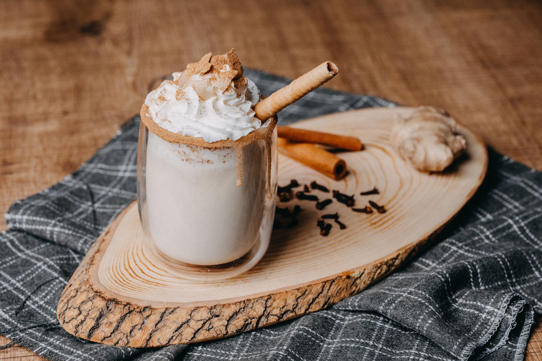 Spiced whipped cream dolloped on roasted pineapple garnished with toasted coconut