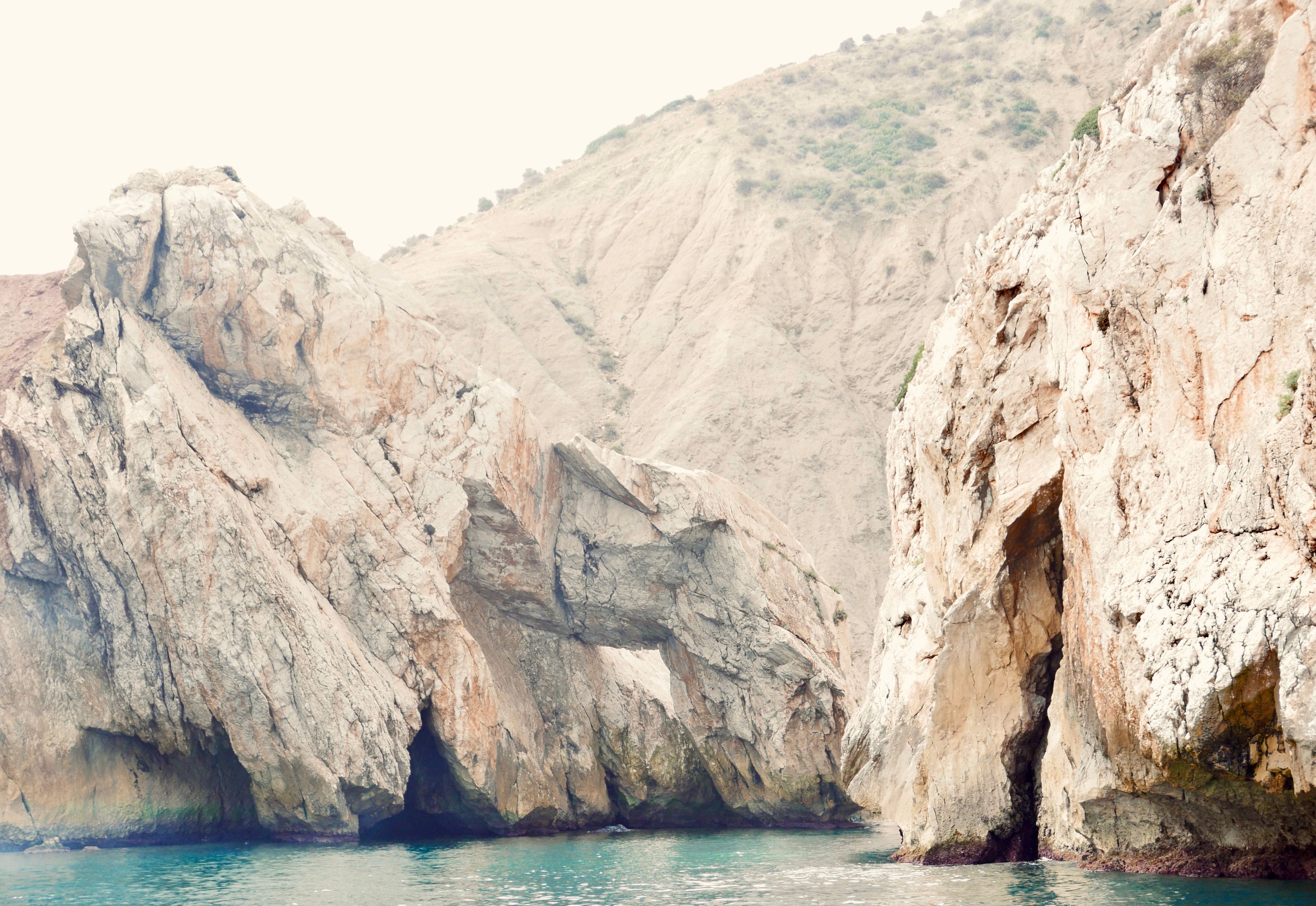 Explore the stunning rocky cliffs and serene coastal landscapes of El Jebha, Morocco.