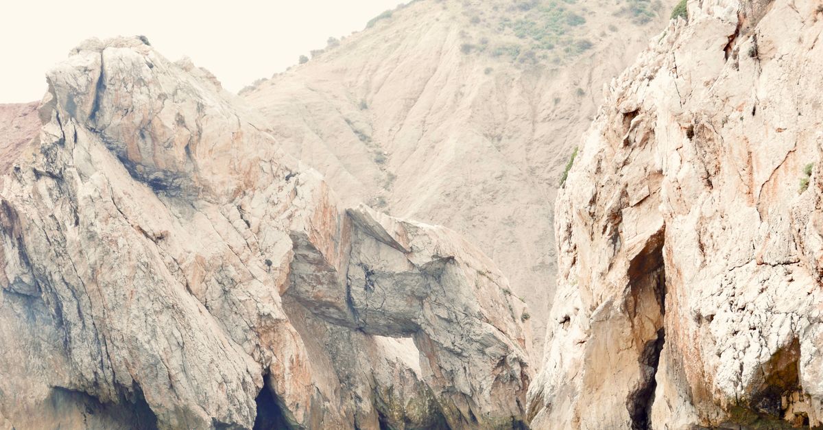 Explore the stunning rocky cliffs and serene coastal landscapes of El Jebha, Morocco.
