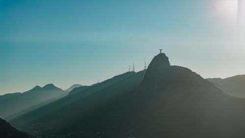 Free View of Christ the Redeemer at sunset, highlighting Rio de Janeiro's iconic landscape. Stock Photo