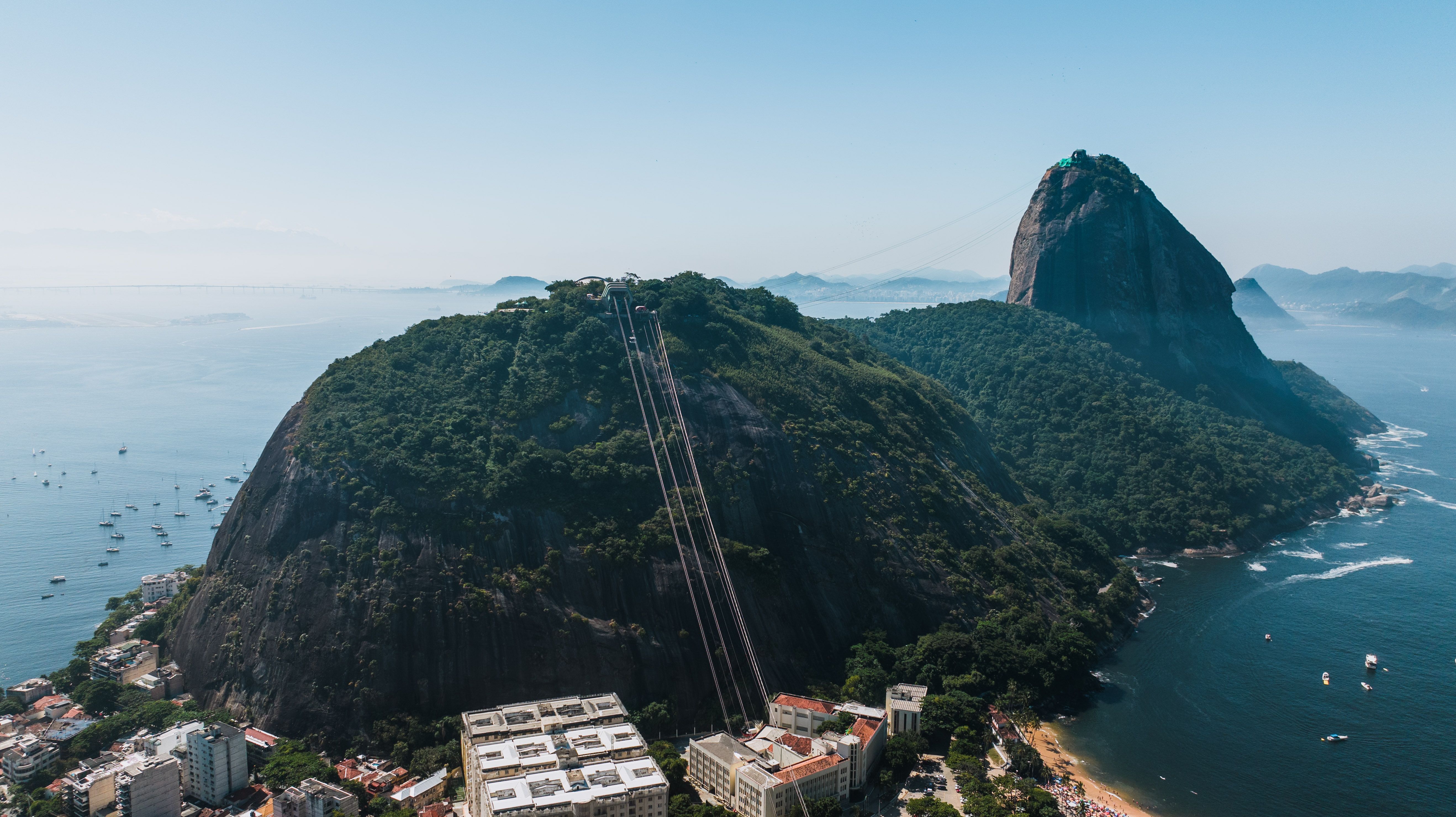 Explore the breathtaking aerial view of Sugarloaf Mountain and the stunning coastline in Rio de Janeiro, Brazil.