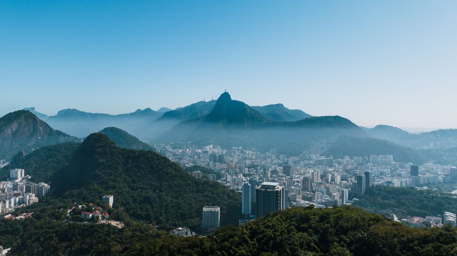 Unbeatable Rio : Helicopter tour at Christ the Redeemer - 30 minutes Review Review 2026 - Aerial view of Rio de Janeiro with mountains and cityscape under a clear blue sky.