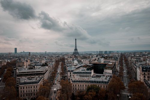 Free A stunning aerial view of Paris showcasing the iconic Eiffel Tower under cloudy skies. Stock Photo