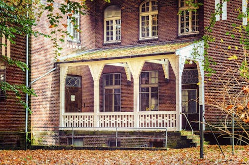 Brown Brick House With White Patio