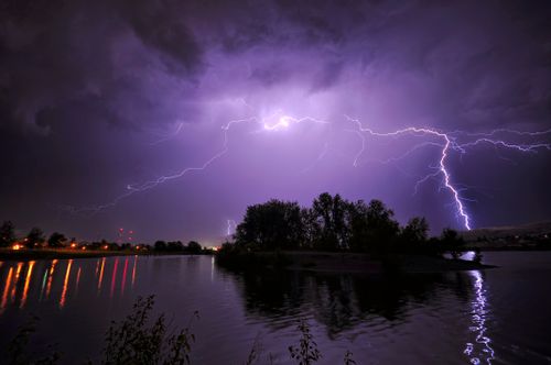 Free Captivating long exposure of a lightning storm illuminating the night sky over a tranquil lake in Wenatchee, WA. Stock Photo