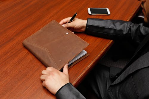 Free Person Holding Brown Leather Book Stock Photo