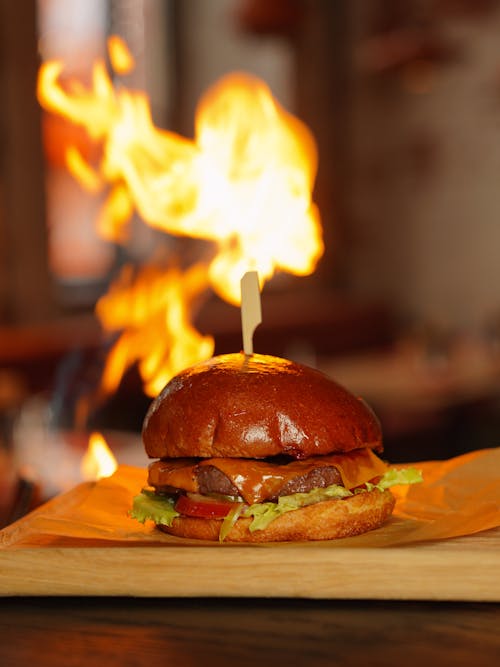 A burger with a flame on top of it